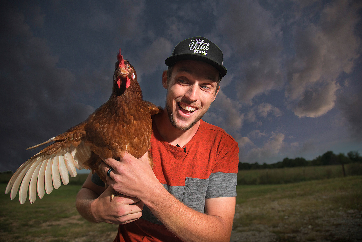 advertising portrait of farmer with chicken