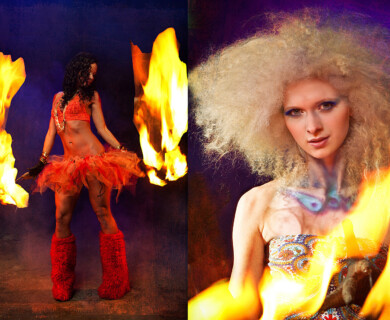 Two performers with fire, red outfit and fluffy boots, light hair and body paint, dark backdrop.